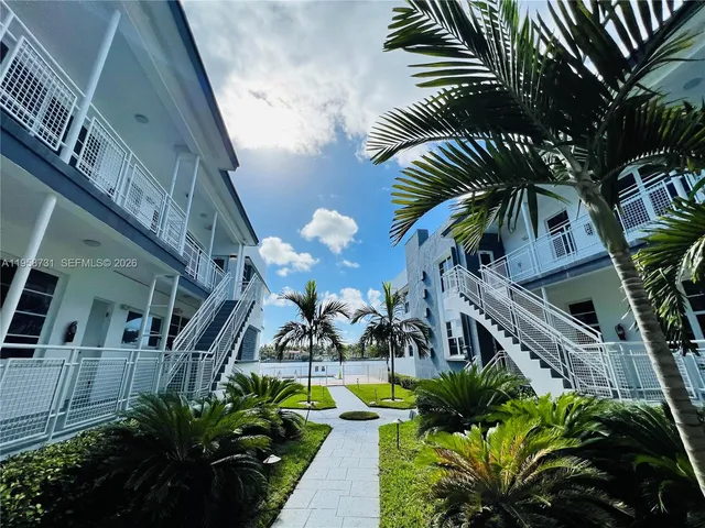 a view of swimming pool with outdoor seating and plants