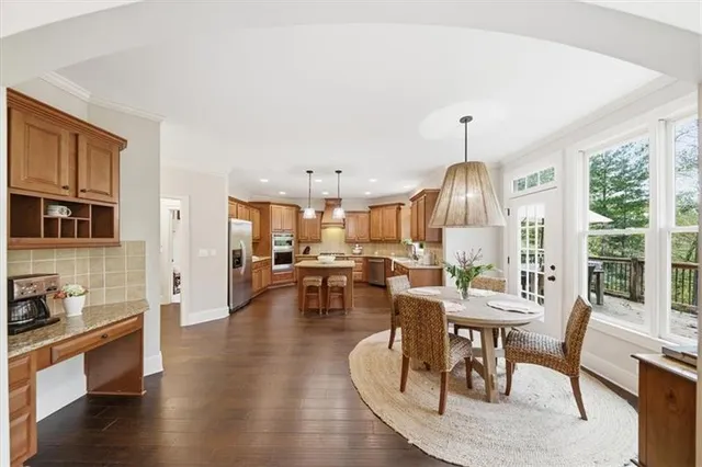 a view of a patio with table and chairs under an umbrella