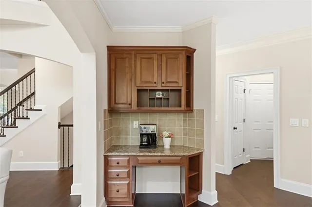 a kitchen with stainless steel appliances granite countertop a sink a stove a refrigerator cabinets and a kitchen island