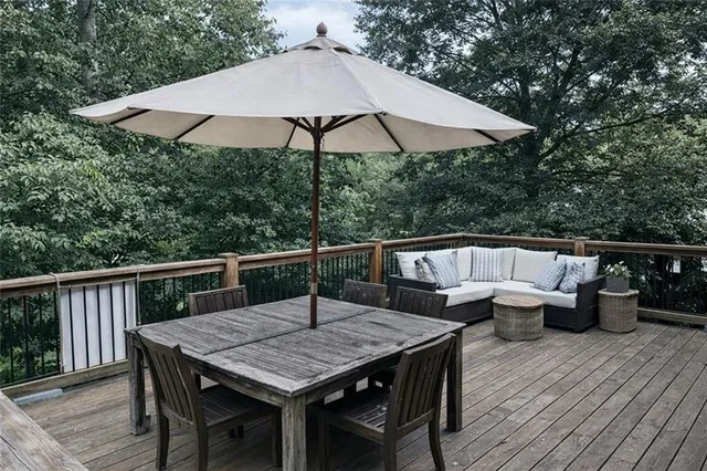 an aerial view of a house with swimming pool and large trees