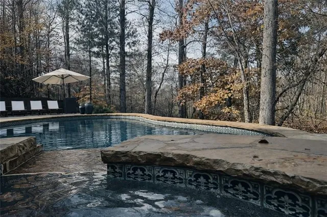 a view of a patio with table and chairs under an umbrella
