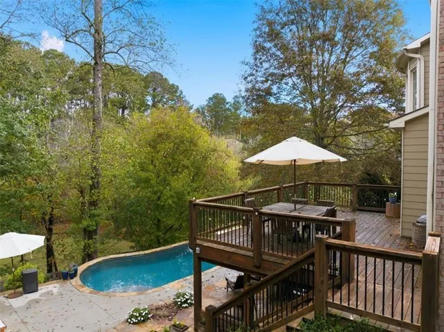 a view of a backyard with large trees