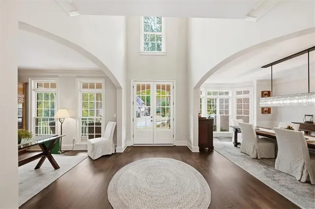a view of a livingroom with furniture hardwood floor and windows