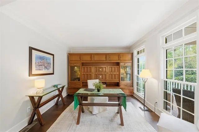 a living room with furniture a table and a large window
