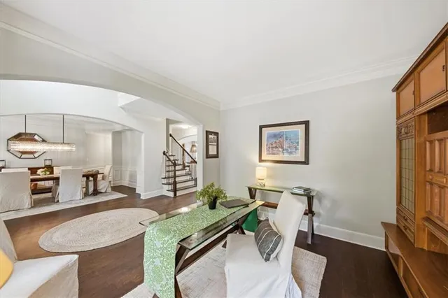 a living room with furniture a flat screen tv and a table