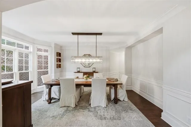 a living room with furniture a rug and white walls