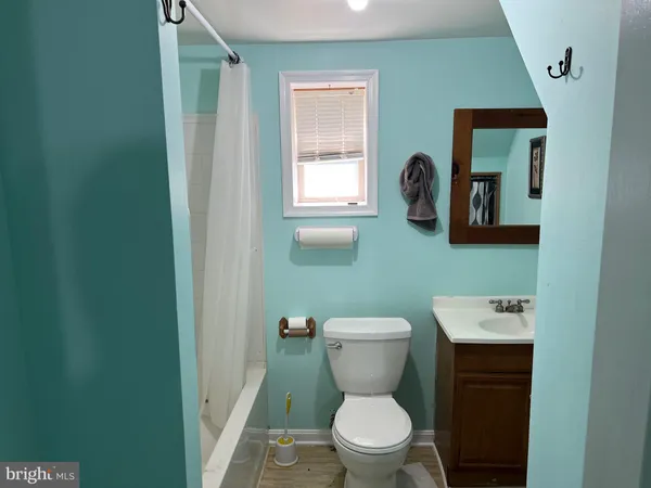 a bathroom with a toilet a sink and mirror