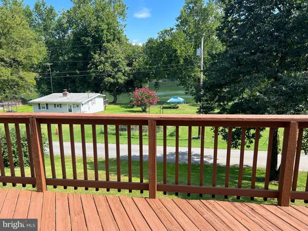 a view of balcony with wooden floor and fence