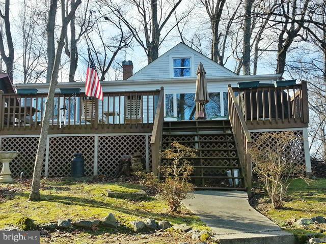 6003 Hill Road St. Leonard, MD 20685 - Photo 2 of 19 front view of a house with a blue gate