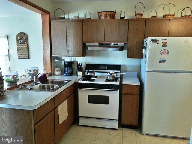 6003 Hill Road St. Leonard, MD 20685 - Photo 16 of 19 a kitchen with a sink a stove and refrigerator