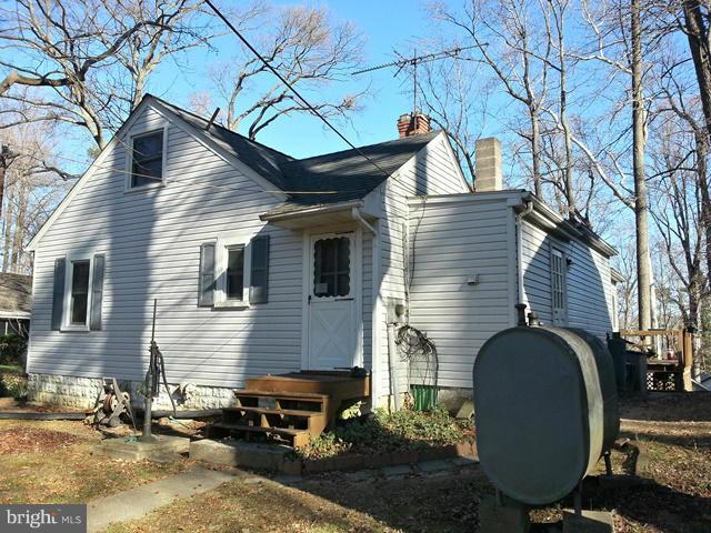 6003 Hill Road St. Leonard, MD 20685 - Photo 18 of 19 a backyard of a house with barbeque oven and outdoor seating