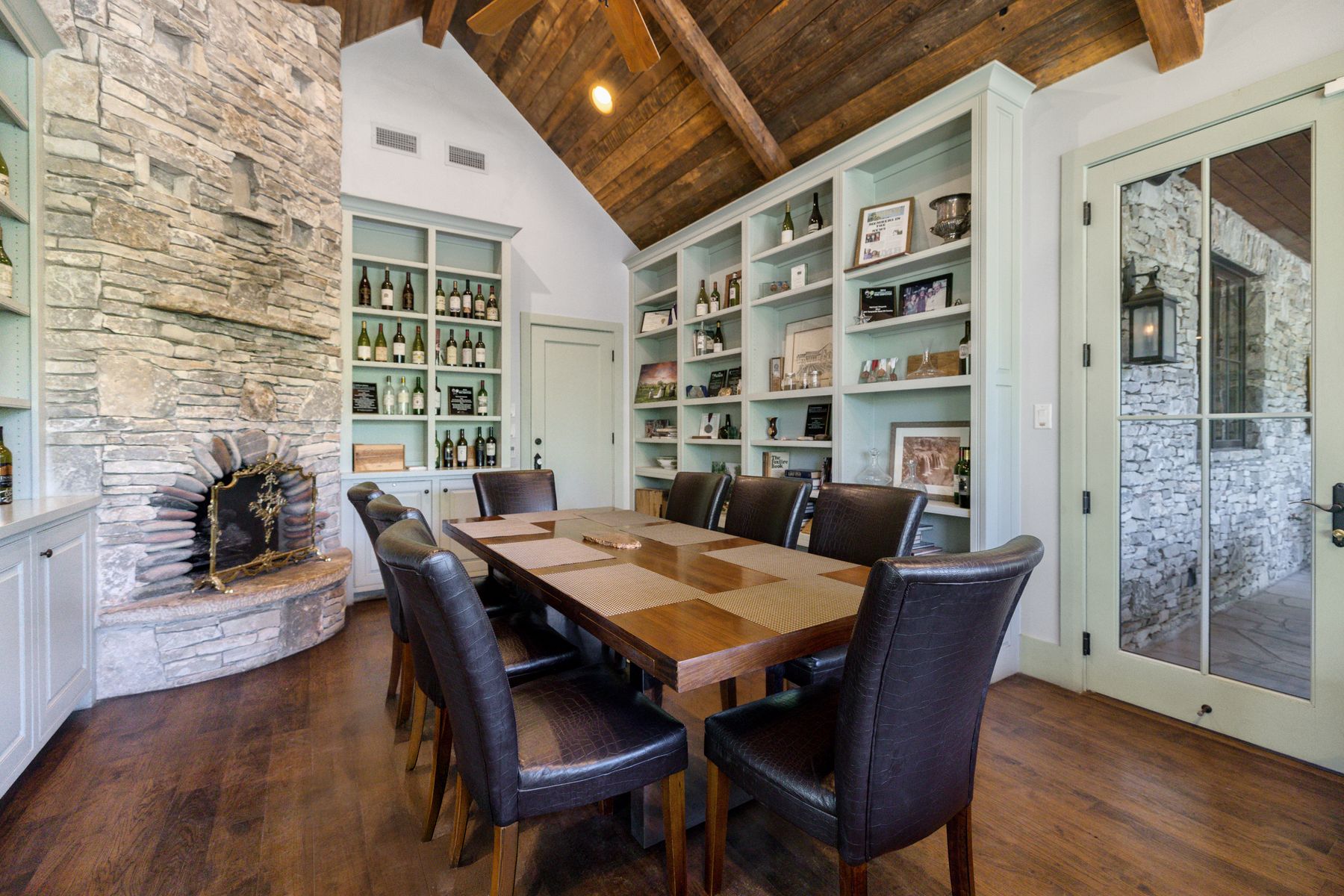 18059 Ranch To Market Road 1826 Buda, TX 78610 - Photo 28 of 39 Dining area with a fireplace, dark wood finished floors, and a high wooden beamed ceiling