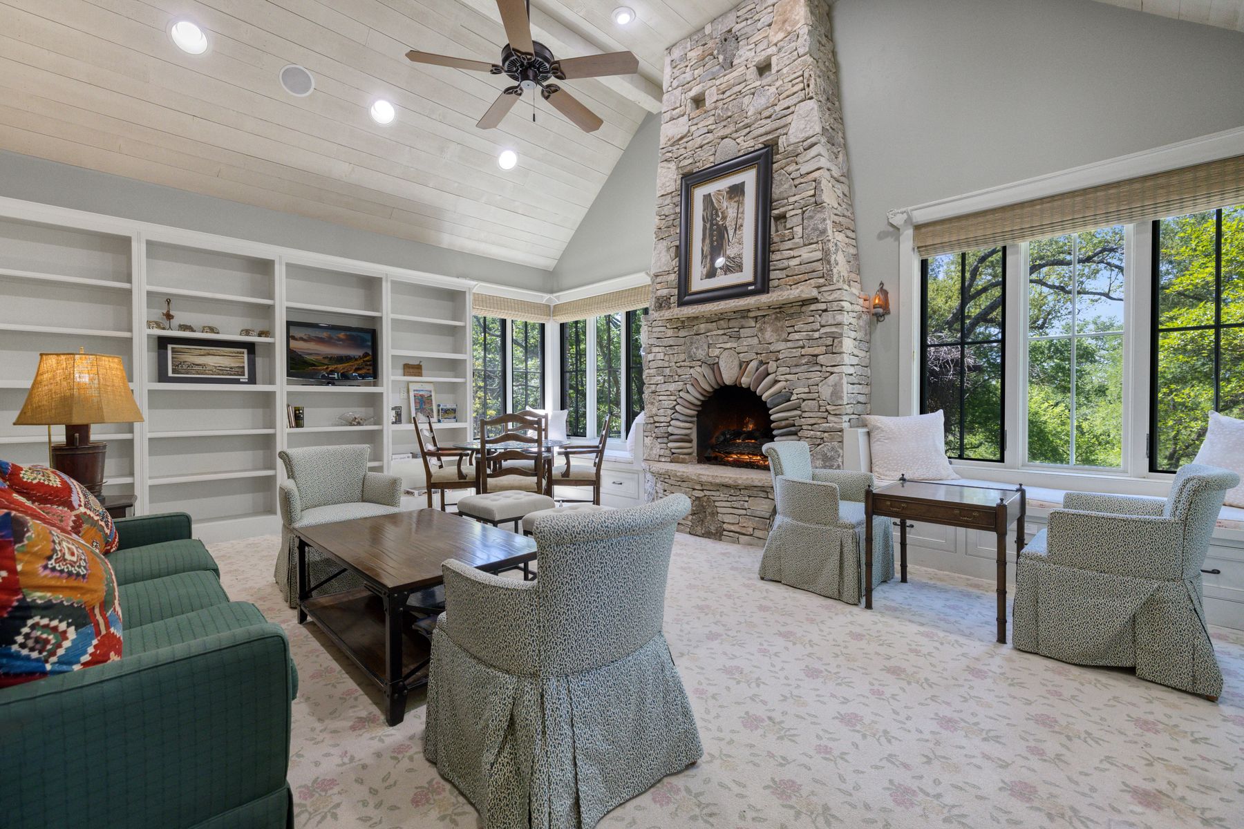18059 Ranch To Market Road 1826 Buda, TX 78610 - Photo 32 of 39 Living area with ceiling fan, a vaulted wooden ceiling, a stone fireplace, carpet floors, and built in features