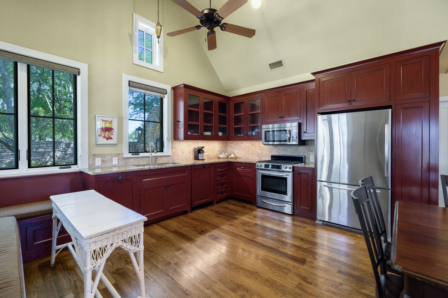 18059 Ranch To Market Road 1826 Buda, TX 78610 - Photo 35 of 39 Kitchen with stainless steel appliances, glass fronted cabinets, lofted ceiling, ceiling fan, and dark wood-style floors
