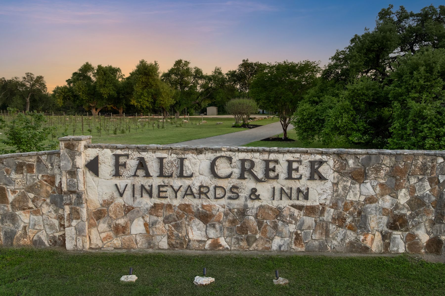 18059 Ranch To Market Road 1826 Buda, TX 78610 - Photo 6 of 39 Community sign with a lawn and view of scattered trees
