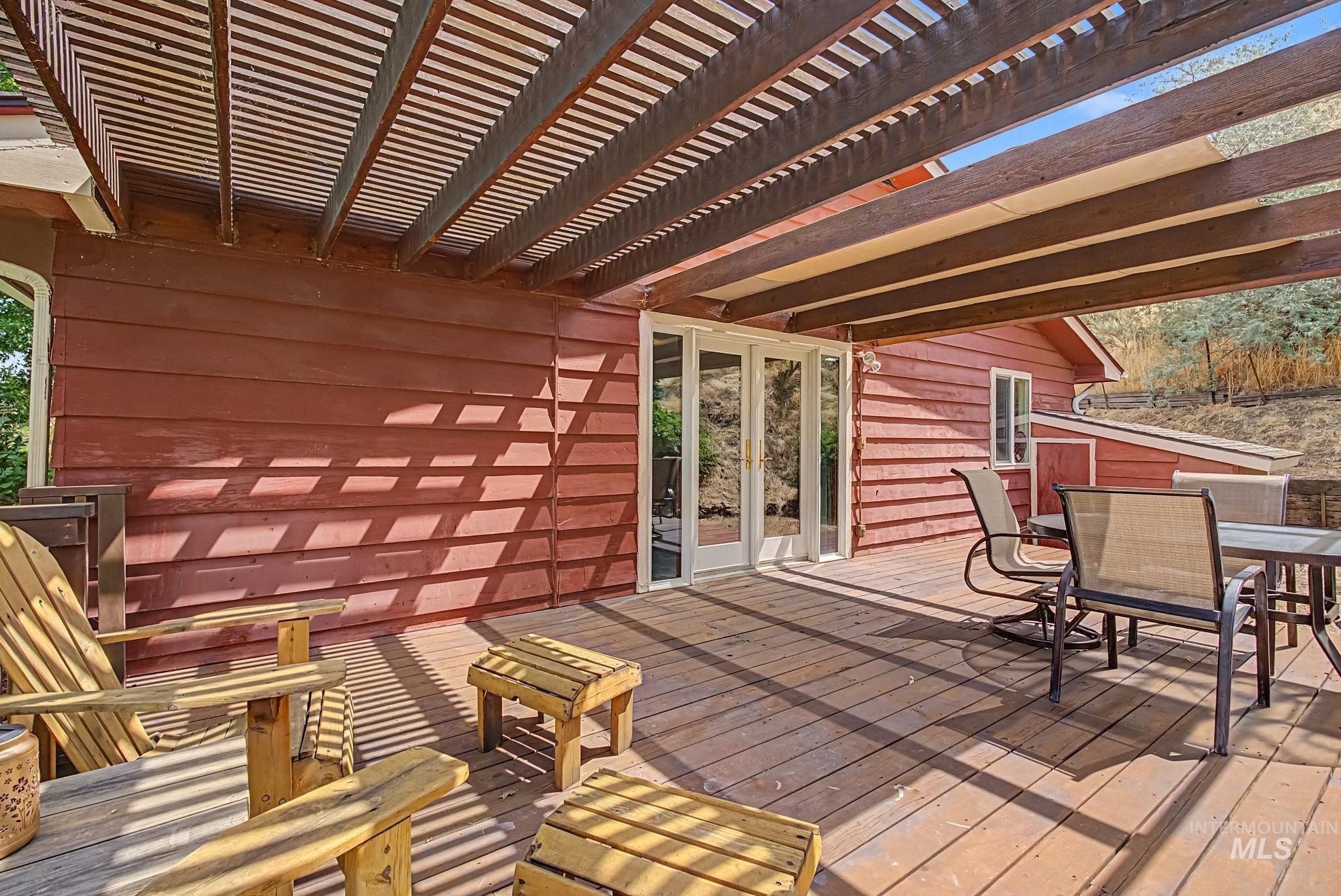 4311 Frozen Dog Road Emmett, ID 83617 - Photo 8 of 31 Expansive wood deck with a slatted pergola overhead