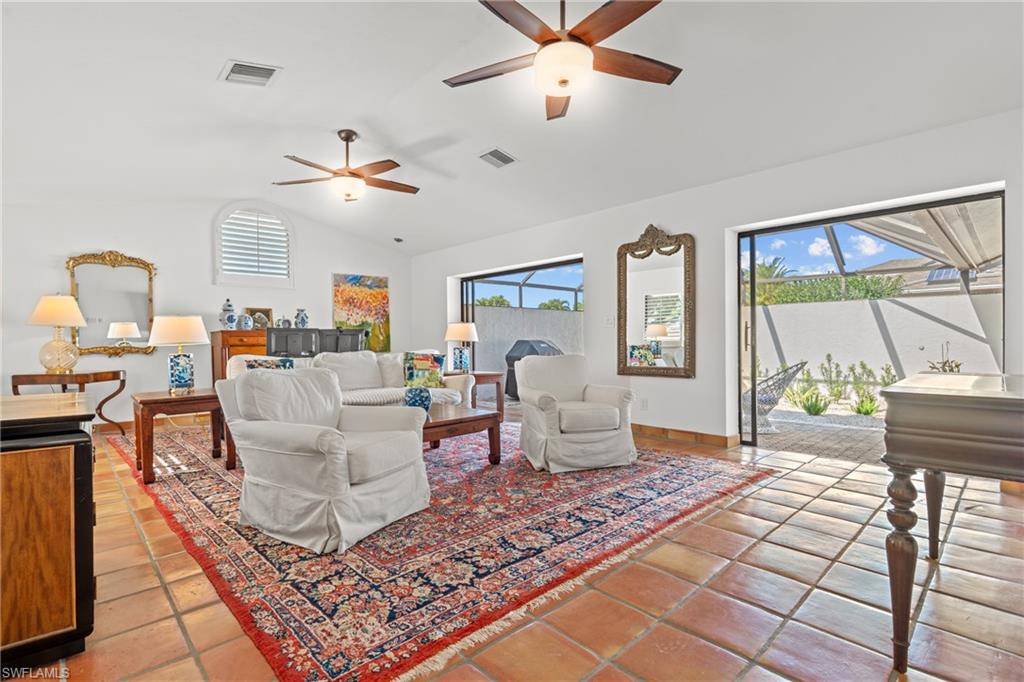 2419 Pinewoods Circle, Unit 11 Naples, FL 34105 - Photo 11 of 32 a living room with fireplace furniture and a large window