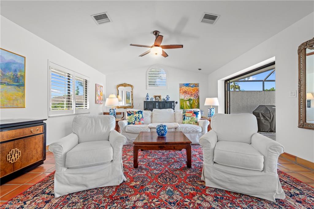 2419 Pinewoods Circle, Unit 11 Naples, FL 34105 - Photo 12 of 32 a living room with furniture and a large window