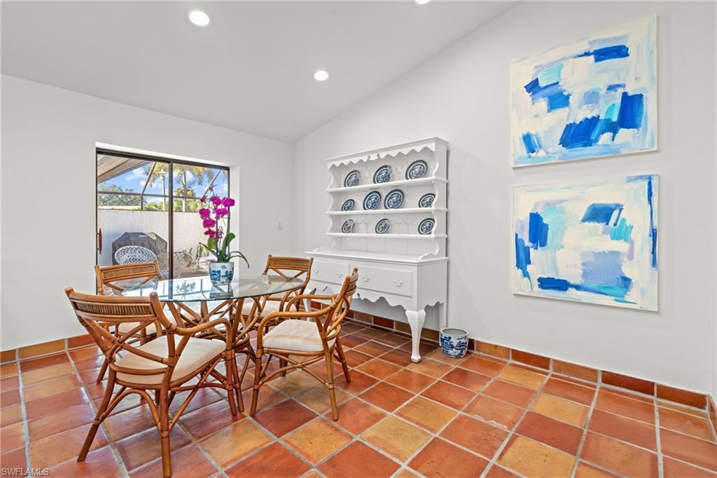 2419 Pinewoods Circle, Unit 11 Naples, FL 34105 - Photo 14 of 32 a dining room with furniture and a kitchen view