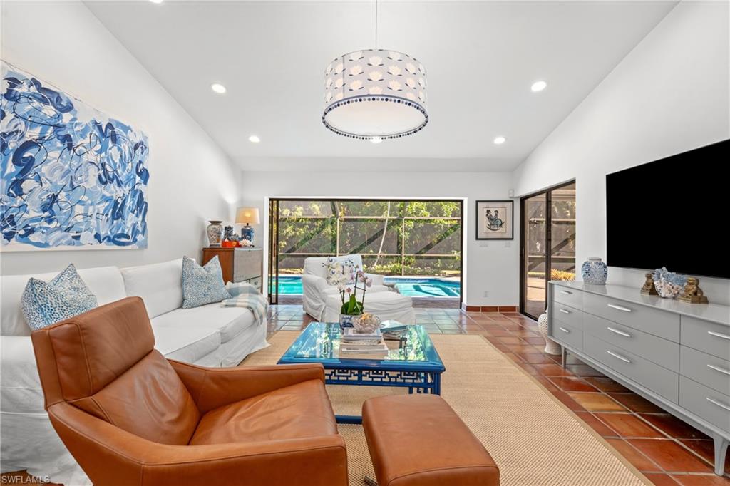 2419 Pinewoods Circle, Unit 11 Naples, FL 34105 - Photo 18 of 32 a living room with furniture and a flat screen tv