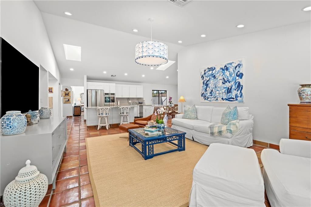 2419 Pinewoods Circle, Unit 11 Naples, FL 34105 - Photo 19 of 32 a living room with furniture and a flat screen tv
