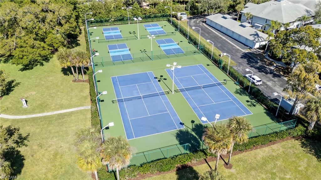 2419 Pinewoods Circle, Unit 11 Naples, FL 34105 - Photo 31 of 32 an aerial view of a residential houses with yard