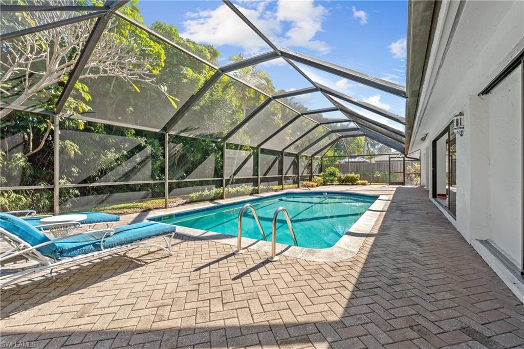 2419 Pinewoods Circle, Unit 11 Naples, FL 34105 - Photo 5 of 32 a view of swimming pool with a bench in wooden floor