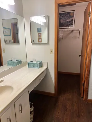 a view of bathroom with a sink and mirror