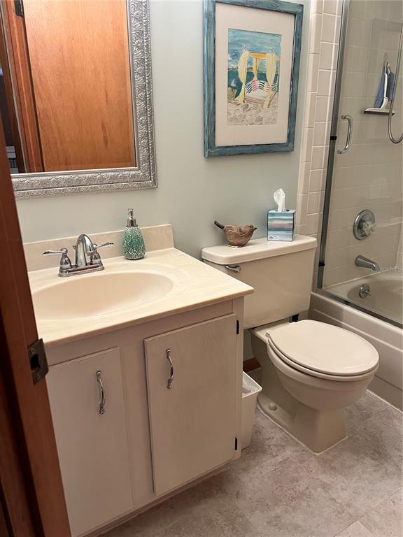 10 Oakmont Court, Unit 10 Palm Coast, FL 32137 - Photo 17 of 19 a bathroom with a toilet a sink and mirror