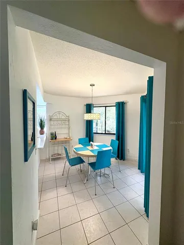 a living room with furniture a window and a table