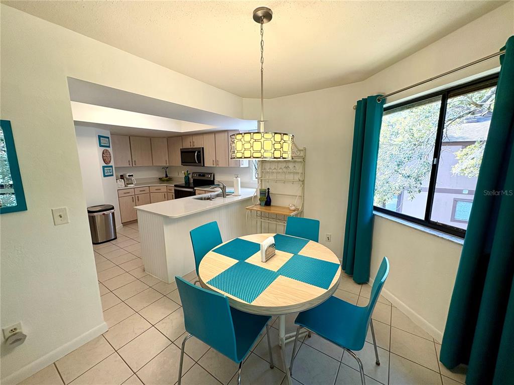 10 Oakmont Court, Unit 10 Palm Coast, FL 32137 - Photo 8 of 19 a view of a dining room with furniture window and wooden floor