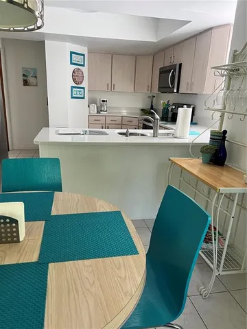 a kitchen with green cabinets a stove and a refrigerator