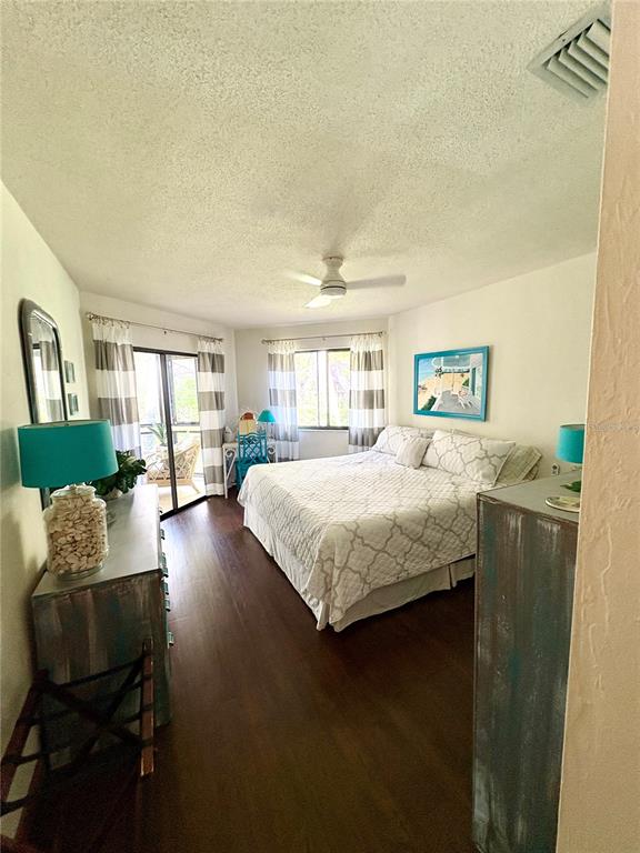 10 Oakmont Court, Unit 10 Palm Coast, FL 32137 - Photo 10 of 19 a bedroom with a bed and wooden floor