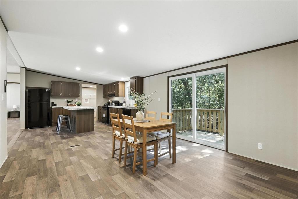 131 Kelly Court Azle, TX 76020 - Photo 12 of 22 a view of a dining room with furniture window and wooden floor