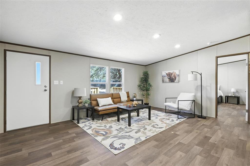 131 Kelly Court Azle, TX 76020 - Photo 5 of 22 a living room with furniture a wooden floor and next to a window