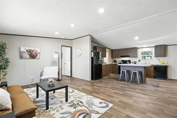 a living room with furniture and kitchen view