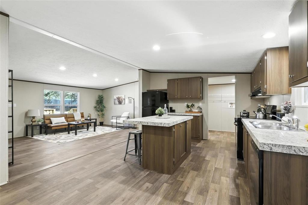 131 Kelly Court Azle, TX 76020 - Photo 9 of 22 a kitchen with stainless steel appliances granite countertop sink stove top oven and cabinets
