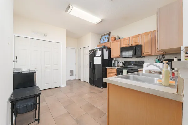 a view of walk in closet with window and hardwood floor