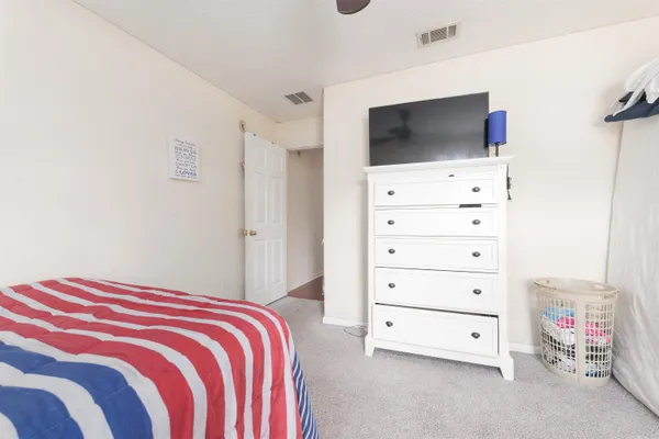 a bedroom that has a bed and a chandelier