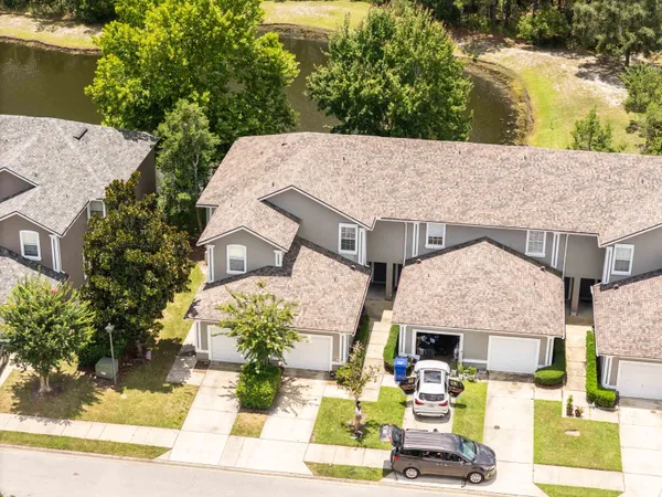 an aerial view of a house with a yard garden and outdoor seating