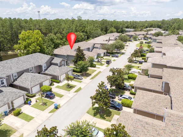 an aerial view of a house with swimming pool and garden