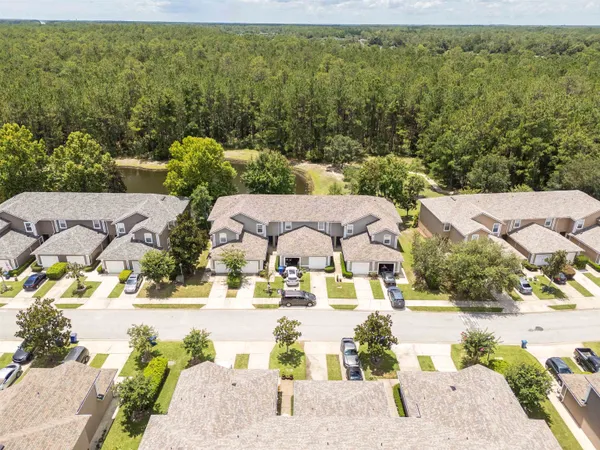 an aerial view of a house with a swimming pool and garden