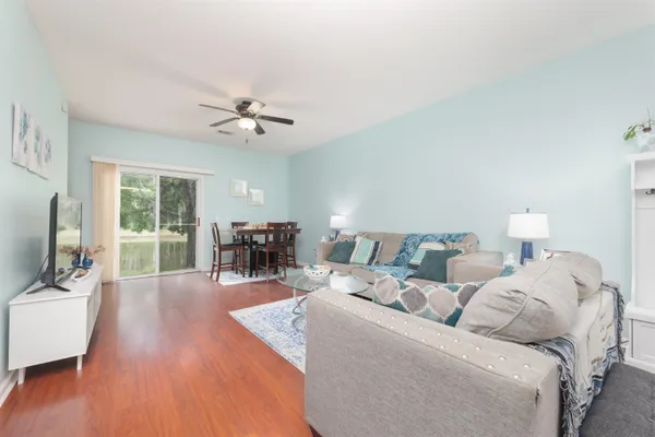 a kitchen with stainless steel appliances granite countertop a stove top oven a sink dishwasher and a refrigerator with wooden cabinets