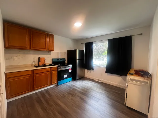 a kitchen with a refrigerator stove and sink