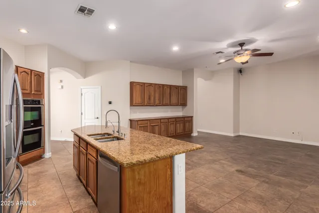 a view of an empty room with a ceiling fan
