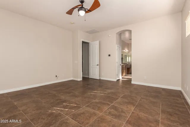 an empty room with entrance and windows