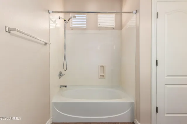 an empty room with closet and windows