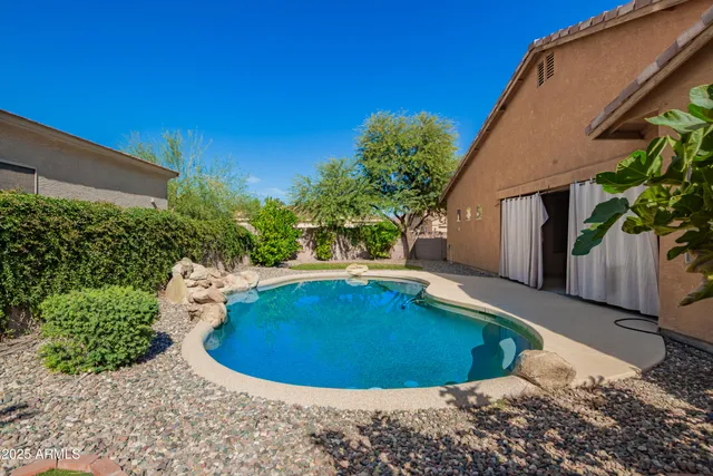 a view of a swimming pool with a yard