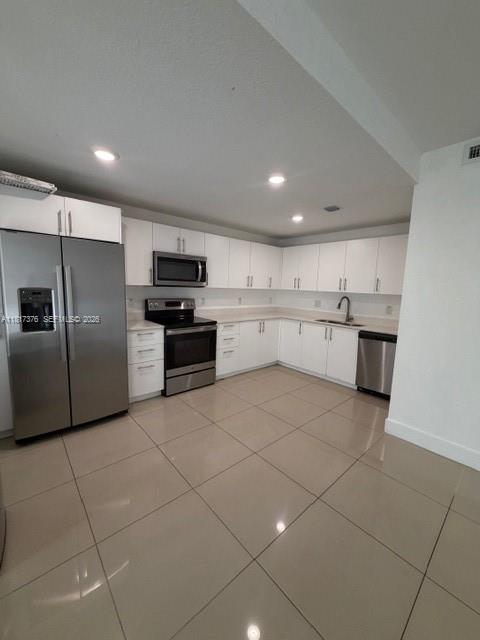 25870 Southwest 144th Court Homestead, FL 33032 - Photo 2 of 46 a large kitchen with cabinets and stainless steel appliances