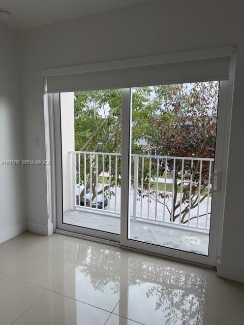 25870 Southwest 144th Court Homestead, FL 33032 - Photo 21 of 46 a view of a room with a large window and wooden floor